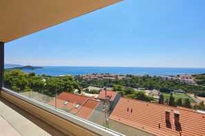 A balcony with a clear view of a coastal town, terracotta-roofed buildings, and a distant sea. - Hedera Estate, Hedera A40 (Dubrovnik)