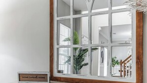 A mirror with a wooden frame and a sign that reads "HOME sweet HOME" on a white surface. - Country Oasis w/ Game Rm, Mins from DWTN & Airport (North Charleston)