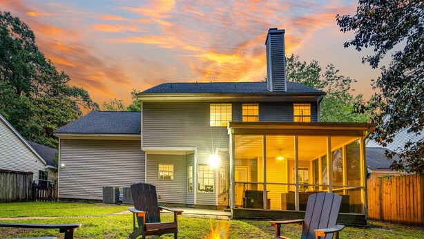 A house with a fire pit in the backyard, a covered patio, and a large window overlooking the yard. - Country Oasis w/ Game Rm, Mins from DWTN & Airport (North Charleston)