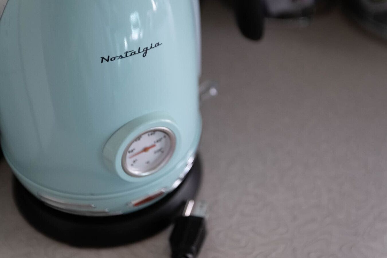 A light blue appliance with a dial and a key.