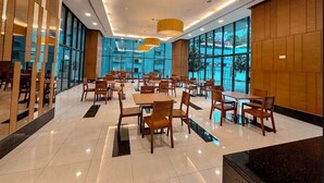 A spacious indoor dining area with multiple tables and chairs, large windows, and modern lighting fixtures. - The Elements at Jalan Ampang (Kuala Lumpur)
