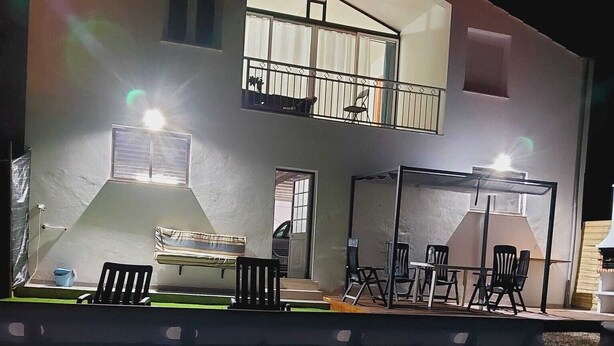 A two-story building with a balcony, outdoor seating area, and a pool. - With a view of Serra de Aire e Candeeiros, with a calm location (Petfriendly). (Cruz da Légua)