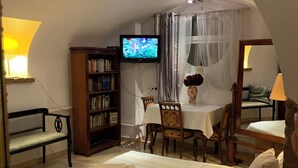 A bedroom with a bed, a desk, a TV, a bookshelf, and a dining table. - Calm escape in historical athmosphere - Villa Giulietta Budapest,  free parking  (Budapest)