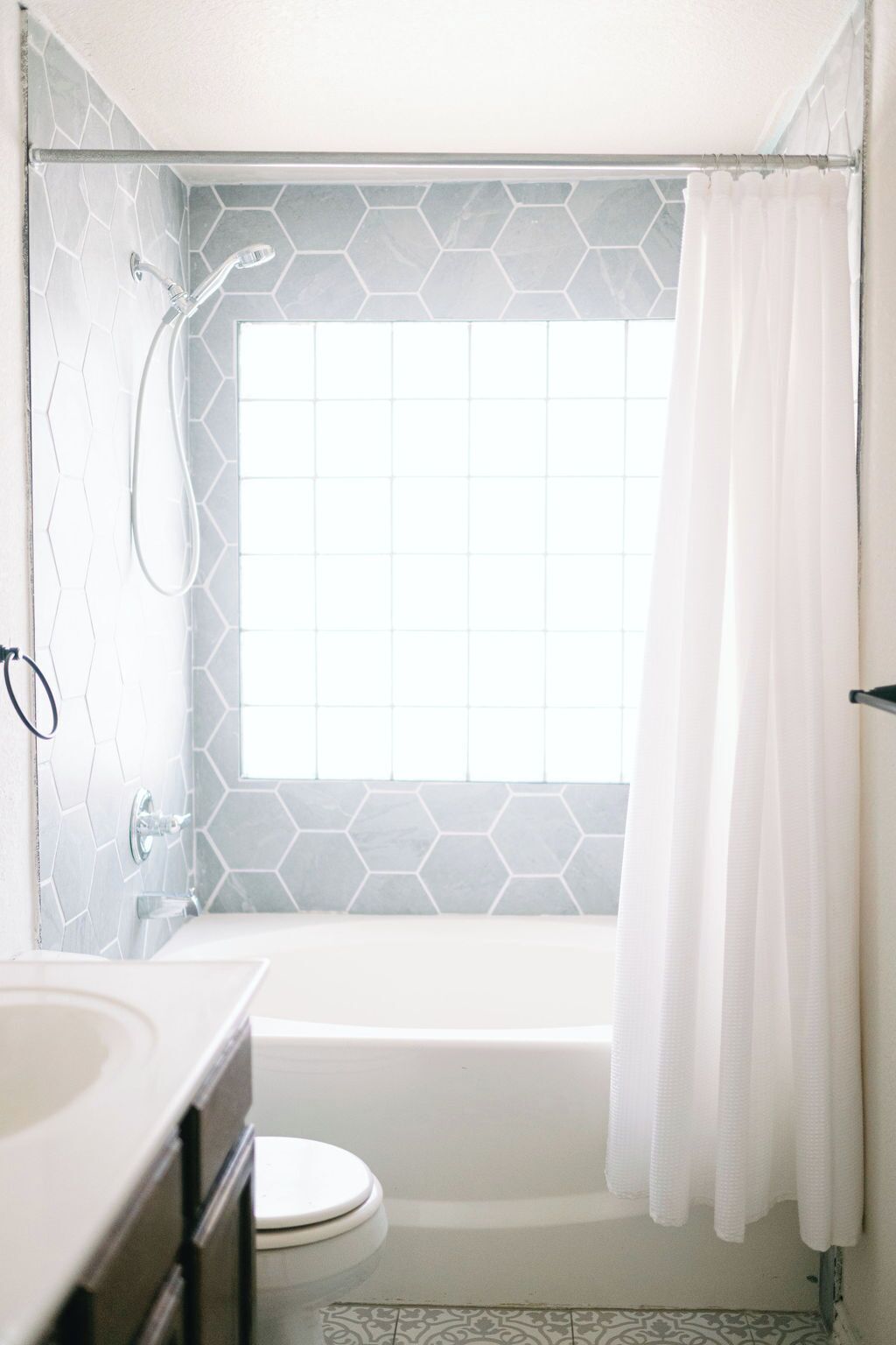 A bathroom with a shower, toilet, and sink.. Fun, Family-Friendly House with Pool + Mini Sports Court + Arcade + Pool Table