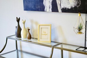 A glass console table with decorative vases and a framed inspirational quote. - Luxury 4BR Family Home w/ King Suite + Game Room (Chico)