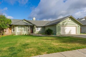 A single-story house with a garage, a front yard, and a clear sky. - Luxury 4BR Family Home w/ King Suite + Game Room (Chico)