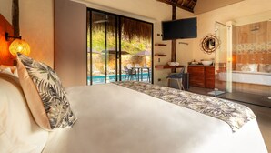 Een slaapkamer met een groot bed, een aan de muur bevestigde televisie, uitzicht op een zwembad en een badkamer met badkuip en wastafel.