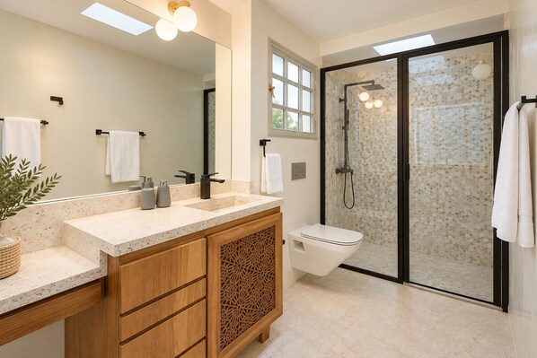 A modern bathroom with a freestanding shower, a large mirror, and a vanity with a sink and cabinet.
