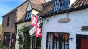 A traditional building with a sign reading 'King John's Cottages.' - Avonmede (Tewkesbury)