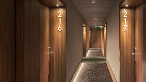 A hotel hallway with wooden doors numbered 216, 217, and 220. - B&B Hotel Vila do Conde  (Vila do Conde)