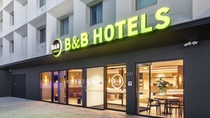A B&B hotel with a modern facade, large glass windows, and a well-lit interior visible through the doors. - B&B Hotel Vila do Conde  (Vila do Conde)