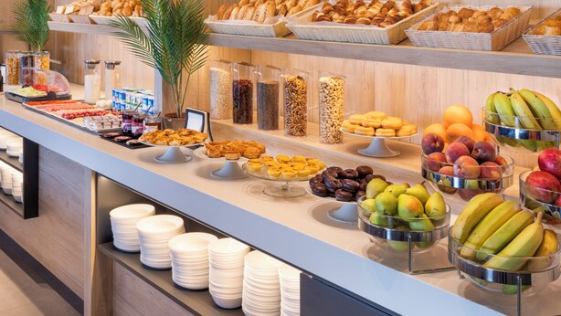 A buffet with various food items including fruits, pastries, and dairy products. - B&B Hotel Vila do Conde  (Vila do Conde)