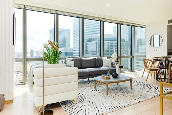 Relax in this stylish living room with a city view, featuring a sofa, couch, and coffee table.