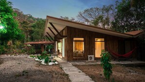 A modern house with a wooden exterior, a covered patio, and a hammock. - Paradise Found!  Spacious Tropical Private Retreat! (Jaco)