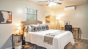 A neatly arranged bedroom with a bed, bedside lamps, a desk, and a ceiling fan. - This house is a 2 bedroom(s), 1 bathrooms, located in Abilene, TX. (Abilene)