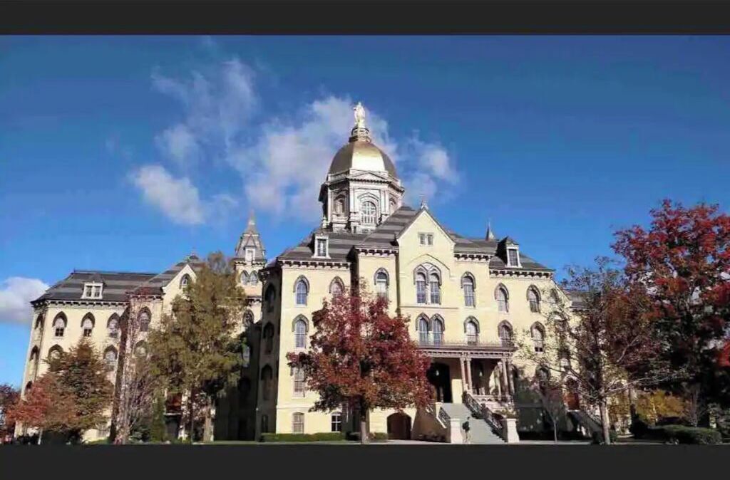 A large, historic building with a prominent dome and multiple towers.