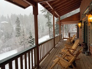 A wooden deck with chairs and a view of a snowy forest. - Beautiful & Cozy Mountain Cabin- less than 5 mins to Burro Street (Mayhill)