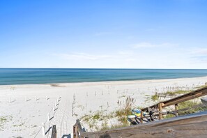 A beach view with a wooden walkway leading to the shore, sandy beach, and ocean. - Game room, swim spa, and more!, Game room, swim spa, and fun! (Gulf County)