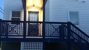 A two-story house with a balcony and a covered entryway. - The Mermaid at Auberge d'Amelia (Fernandina Beach, FL)