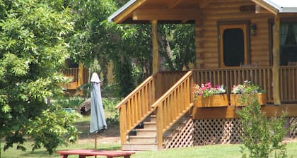 Log cabin overlooking a private lake on a working farm