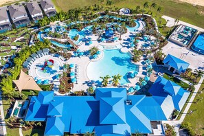 An aerial view of a resort with a large central pool, multiple water slides, and numerous sun loungers. - Best Value Disney Pool/Spa Home! No Carpet! No back neighbor! Resort Amenities! (Davenport)