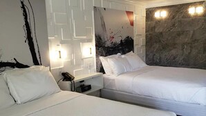 A hotel room with two beds, a white wall with a black abstract painting, a marble wall with lights, and a phone on the nightstand. - Cozy Studio at the Orlando theme parks Neighborhood (Kissimmee)