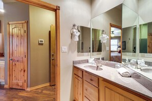 A bathroom with wooden cabinets, a large mirror, and a double sink. - Unwind Fireside: Spacious Torreon Cabin w/ Deck! (Show Low)
