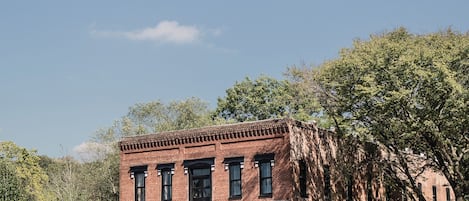A historic brick building with a porch and a sign reading "Chester" in front.