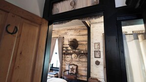 A room with a wooden door, a number '9' sign, rustic decor, a mounted animal head, and a star-patterned chair. - Beard and Lady Inn (Chester)