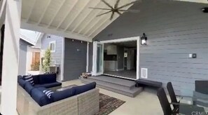 Relax in this outdoor space, featuring a sofa set and glass table, with a unique star-shaped ceiling design.
