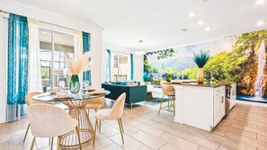 Enjoy meals in a spacious dining area with a glass-top table and comfortable chairs.
