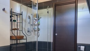 A modern bathroom with a glass-enclosed shower, a wooden vanity, and a bathtub. - -Le Carillon- Romantic and cozy Suite with Jacuzzi 2 steps from Bergamo (Sorisole)
