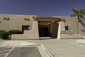 A building entrance with a sign indicating it is the Coyote Lakes Recreation Club.