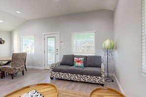 A modern living room with a sofa, a chair, and a floor lamp.