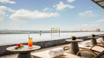 Seasonal outdoor pool, open 1:00 PM to 10:00 PM, pool umbrellas