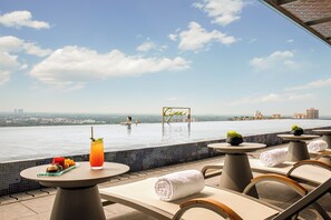 Seasonal outdoor pool, open 1:00 PM to 10:00 PM, pool umbrellas