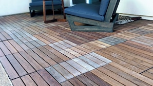 A wooden deck with a blue chair and a small table. - Modern, Spacious, Family friendly & Relaxing Home in Sparks, NV. (Sparks)