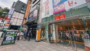 A commercial building with various storefronts, including a visible 'ABC Mart' sign and a 'Uni Qlo' store. - Sky Gate Hotel (Taipei)