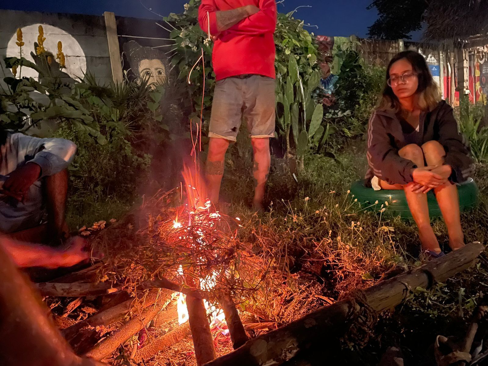 A group of people around a campfire at night.