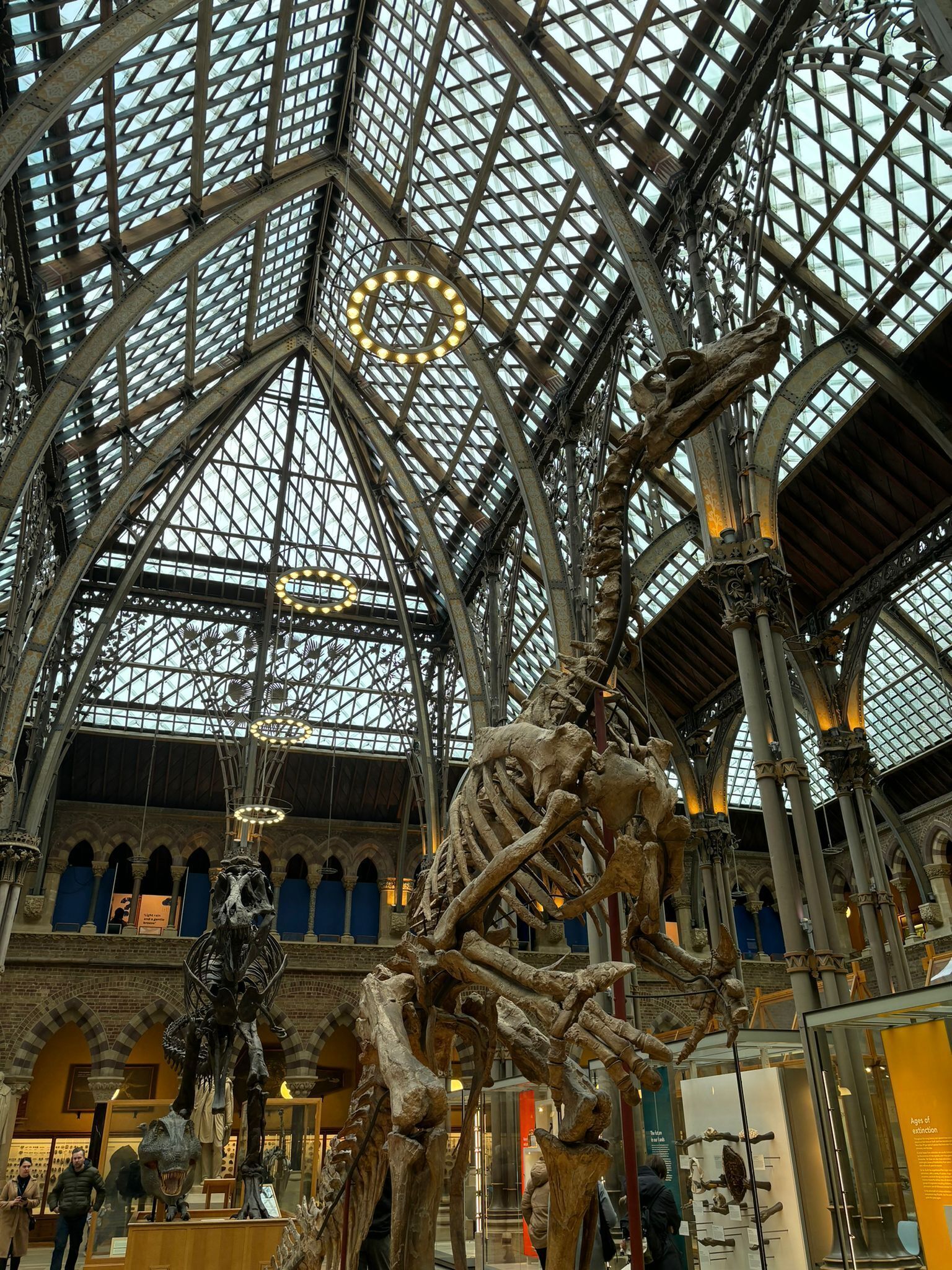 A large indoor exhibition space with a high glass ceiling and metal framework.