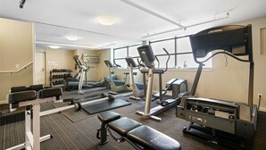 A gym with cardio machines, weight benches, and dumbbells. - 321 Getaway in Seattle Center-Belltown (Seattle)