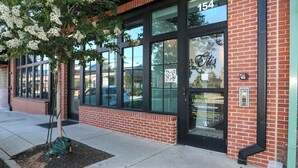A brick building with large windows and a tree in front. - Loft Style Spacious Lux Apt 102, sleeps 6 (Atlanta)