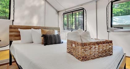 Unplug in comfortâglamping tent with real beds, electricity, fire ring, bathhouse, and nearby pond.
