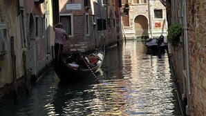 A narrow canal with a gondola, buildings with balconies, and a sign reading "RIO DE CA' TRON". - Sofia's canal-side mansion in San Stae luxury apartment with canal view (Venezia)