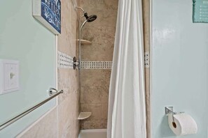 Bathtub, hair dryer, towels, toilet paper