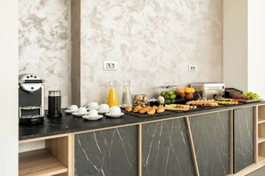 A breakfast buffet with various food items and a coffee machine. - Mirabilis Boutique Hotel  (Kalabaka)