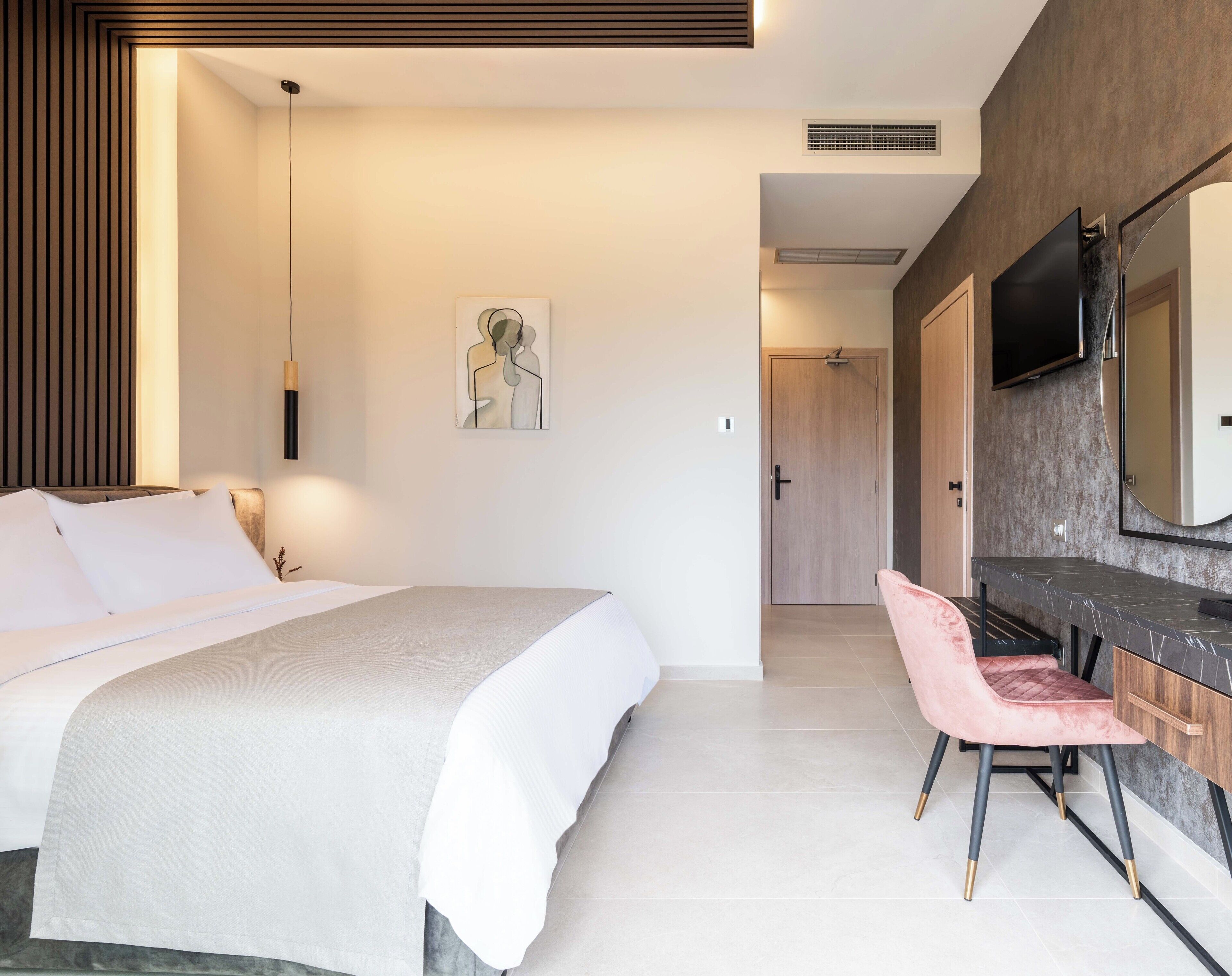 A modern bedroom with a bed, a desk, a chair, a TV, and a painting on the wall.