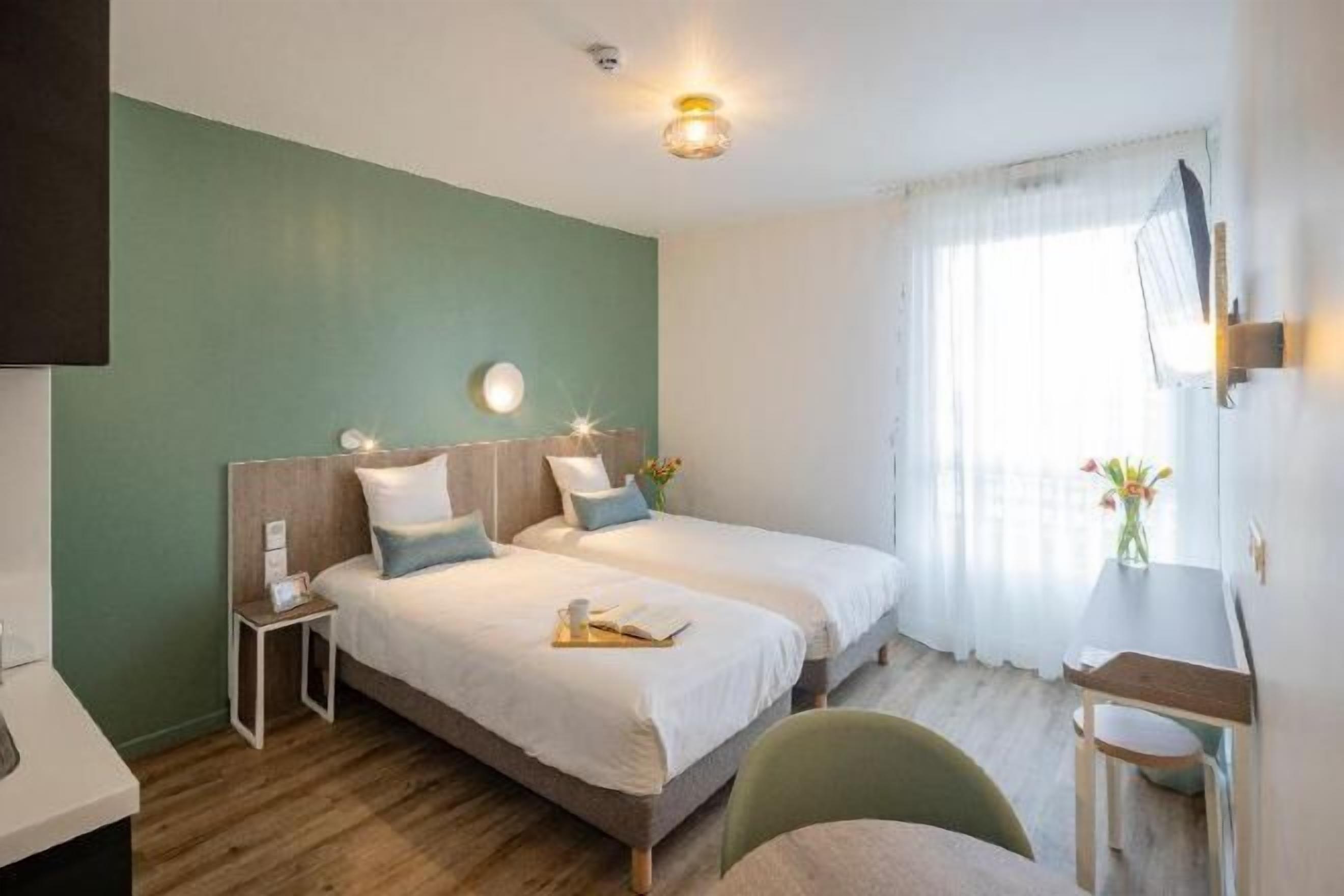 Premium bedding, desk, laptop workspace, blackout drapes