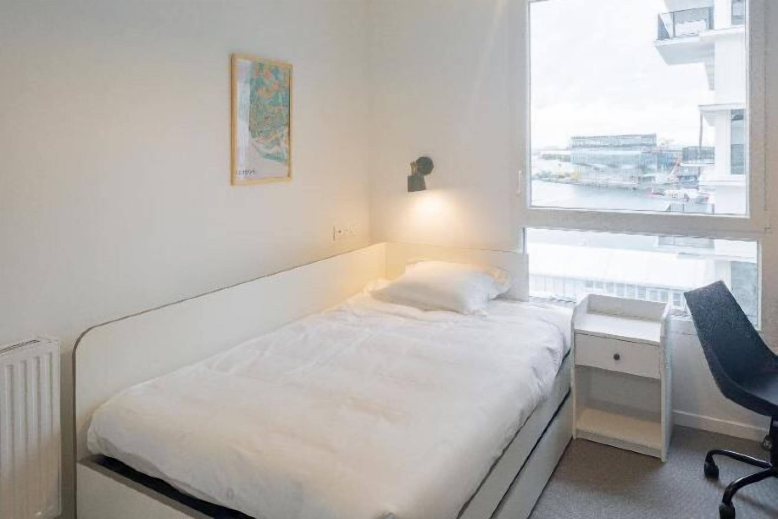 Premium bedding, desk, laptop workspace, blackout drapes