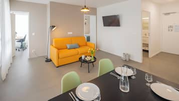 Apartment, 2 double beds and 1 sofa bed | Living area | 32-inch flat-screen TV with digital channels